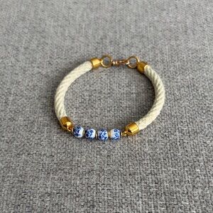 Elegant Gold and Cream Bracelet with Blue Accents